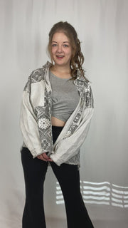 Black and white paisley printed shacket with distressed detailing.