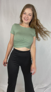 Short-sleeve, sage green, crop top with a cute, twisted detail on the front.